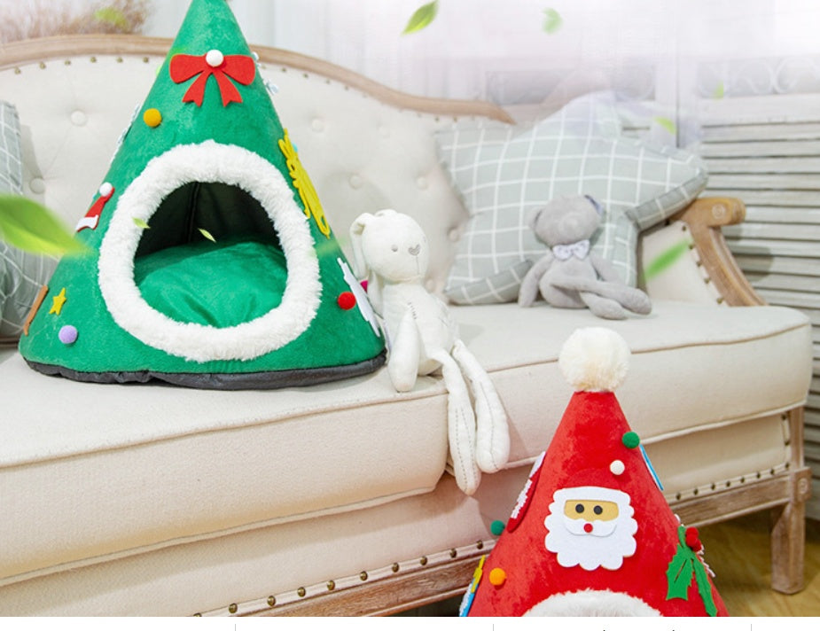 Cat in a red Santa hat shaped cat bed next to a green tree version